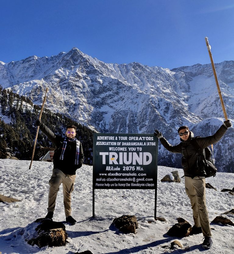 Trekkers on the Triund ridge with mountain views