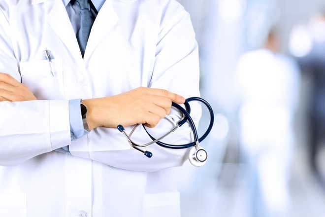 Doctors wear black badges to protest grade pay cut in Himachal