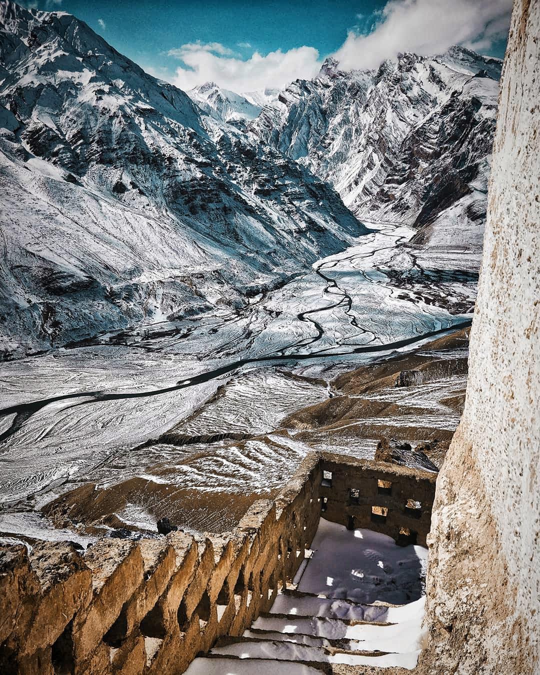 During winter the barren mountains of the Spiti valley get metamorphosed into snowy wonderland. I took this picture while descending from the balcony of Dhankar monastery. Spiti river can be seen meandering below.